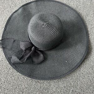 stylish black straw sun hat with a floppy wide brim